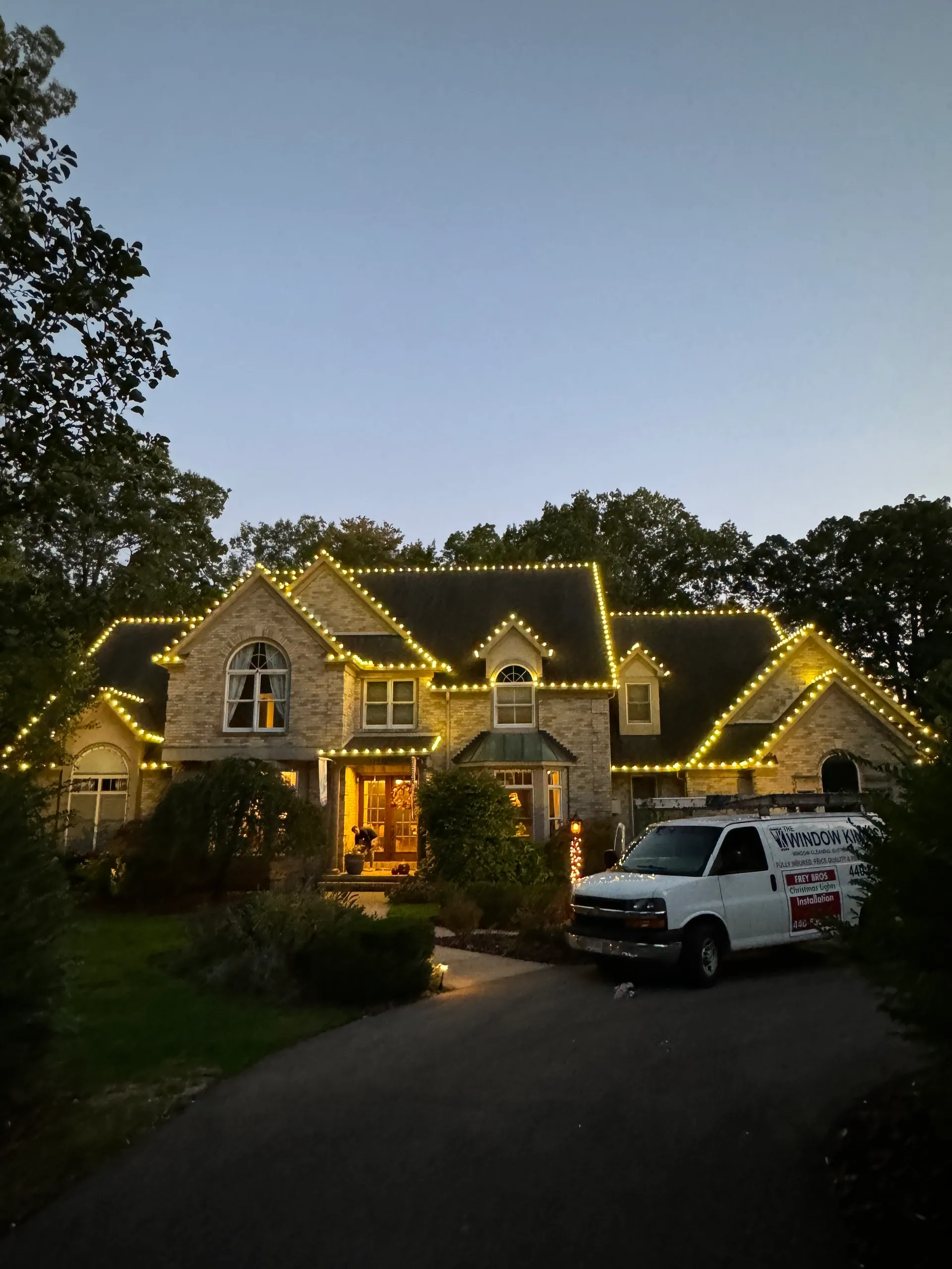 Stunning holiday lighting display on luxury home exterior